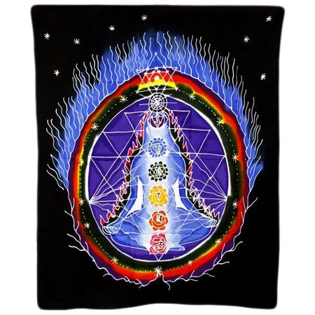 A vibrant batik wall hanging with a central figure and rainbow chakra symbols on a black background