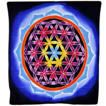 Batik wall hanging silk scarf with vibrant tie-dye flower of life pattern in pink yellow purple on blue background