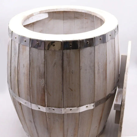 A rustic beer barrel table with light gray weathered wood planks and shiny metal bands in whitewash finish