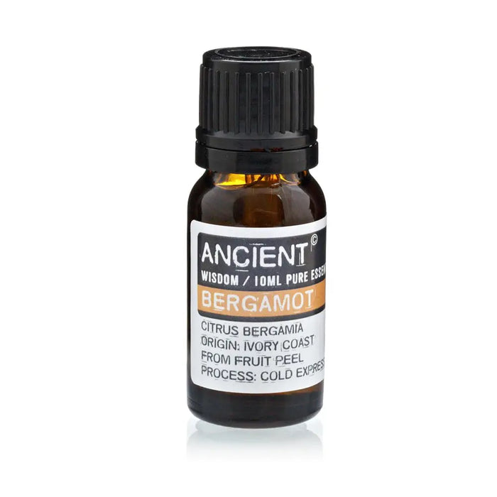 A small amber glass bottle with black cap labeled ancient wisdom bergamot essential oil 10ml for aromatherapy use