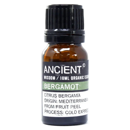 A small amber glass bottle with black cap labeled ancient wisdom 10ml organic essential bergamot organic essential oil