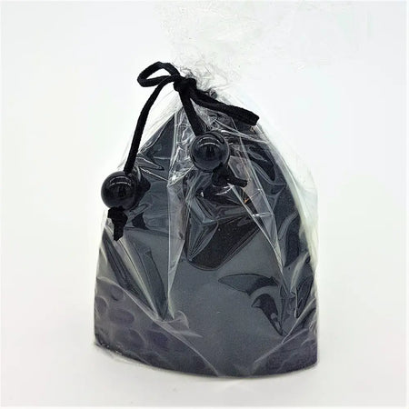 Black bishops hat candle in a black glossy drawstring pouch with decorative black beads on the cord