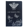 Dark blue textured gratitude journal with white line art of moth bird butterfly mushrooms and i am thankful for text