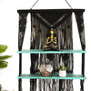 Black macrame hanging shelves with turquoise wash and two shelves holding decorative items on a wall display