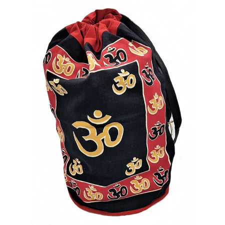 Black cotton duffle bag with red trim and gold om symbols block-printed across its surface with drawstring closure
