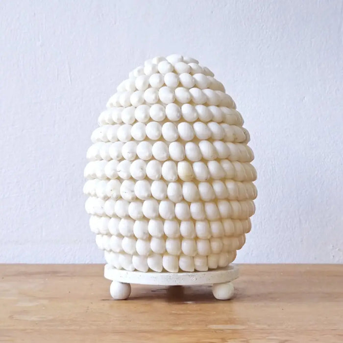 White oval 15cm boho buting shell lamp made of small rounded beads in a textured egg-shaped design