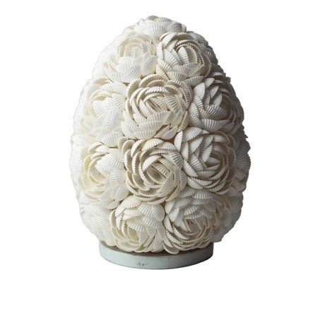 A white boho sea shell lamp shaped like an egg with rose oval 20cm patterns made from arranged seashells