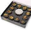 Box of 12 black frankincense incense resin cups with a silver lotus-shaped incense burner in the center