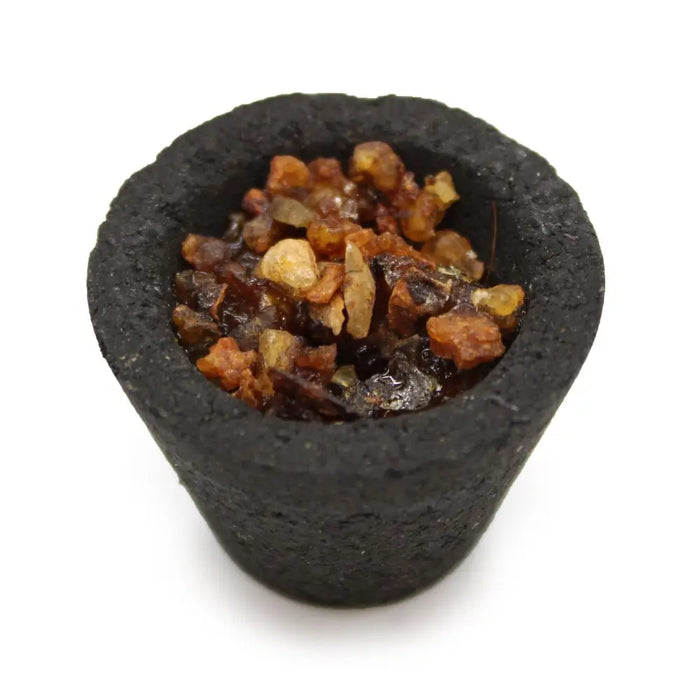 Black textured incense resin cup filled with amber and brown myrrh resin fragments in a box of 12 cups