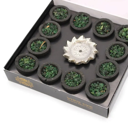 Set of 12 black resin incense cups with green white sage crystals arranged around a silver lotus burner in a gift box