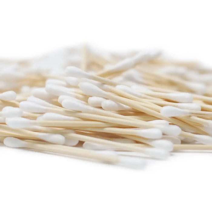 A pile of white cotton tipped bamboo cotton buds made of natural wood sticks in a box of 200 pieces