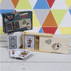 Wooden box set with playing cards and dice showing a joker card inside for game nights and casual play