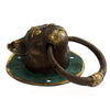 Antique brass door knocker shaped like a cat head with green patina base and gold accented eyes
