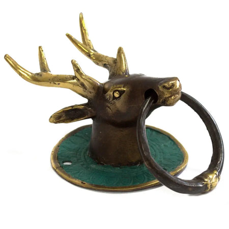 Antique brass door knocker featuring a stag head with a green enamel base and black ring for door use