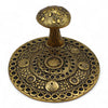 Golden brass effect incense holder shaped like a mushroom with intricate circular patterns and a textured stem