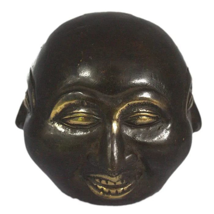 Dark bronze brass four face buddha mask with gold leaf eyes and teeth showing a smiling expression 10cm tall