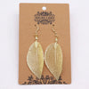 Bravery leaf earrings gold with intricate vein details and delicate wire hooks made from gold-colored metal