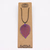 A multi coloured iridescent metal bravery leaf necklace pendant shaped like a leaf on a black cord