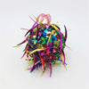 A bright multi-coloured sequinned bauble with spiked sequins and metallic ribbons in small diameter spherical shape