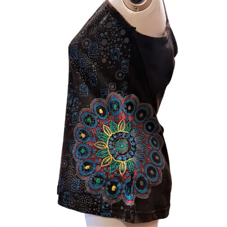 Black sleeveless top with vibrant teal green and gold embroidered mandala paired with brown cotton geometric vest