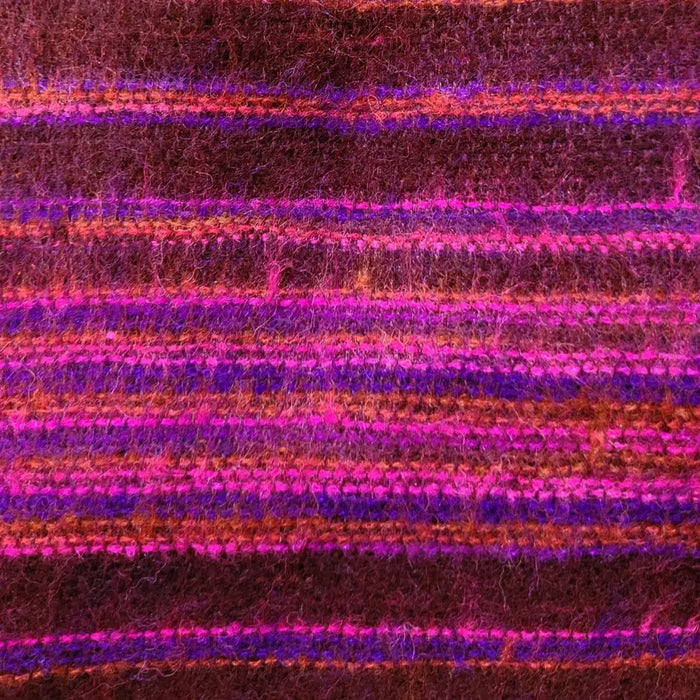 A richly textured scarf with magenta purple and rust stripes paired with brushed cashmelon ali baba trousers