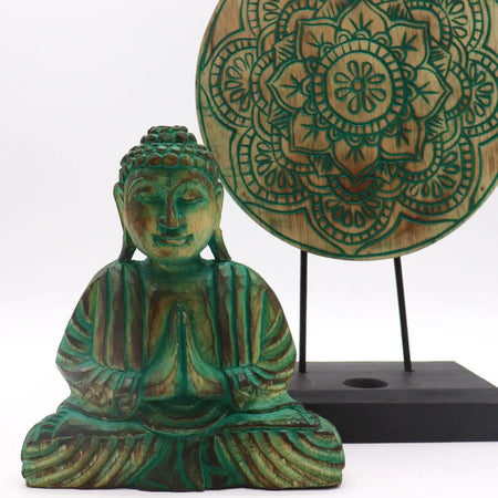 Hand carved wooden buddha statue with green patina and intricate detailing in a buddha feng shui set with buddha knot