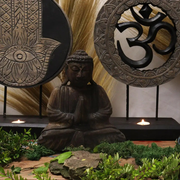 Dark brown wooden buddha feng shui statue with intricate carvings seated in meditation pose for feng shui set
