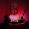 A buddha glow lamp bust with warm red molton lava crackle texture and glowing light inside