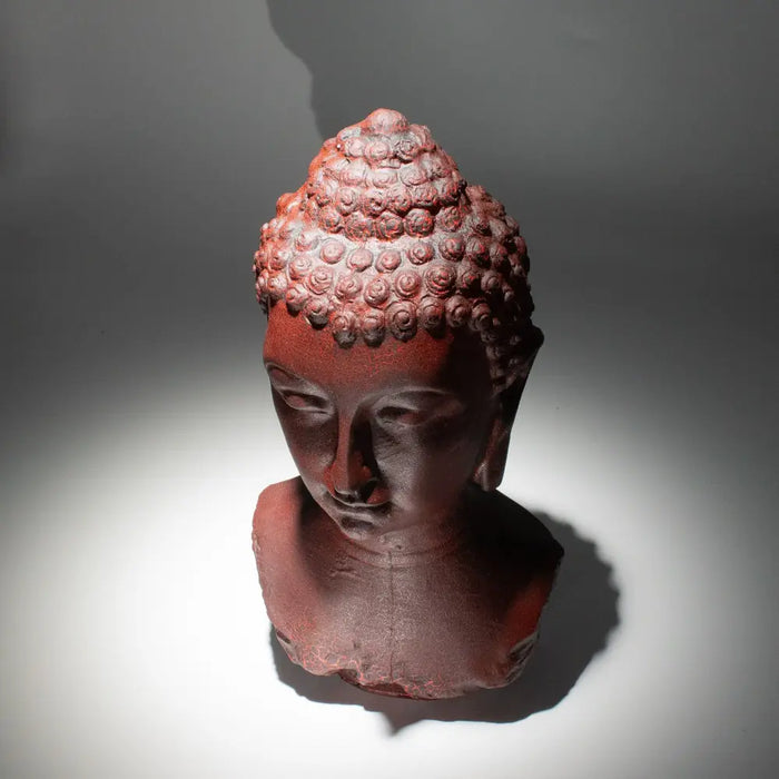Red terracotta buddha glow lamp bust with detailed curls and molton lava crackle finish showing a serene face