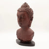 Red-brown buddha bust sculpture with curly hair on a dark wooden base featuring molton lava crackle texture