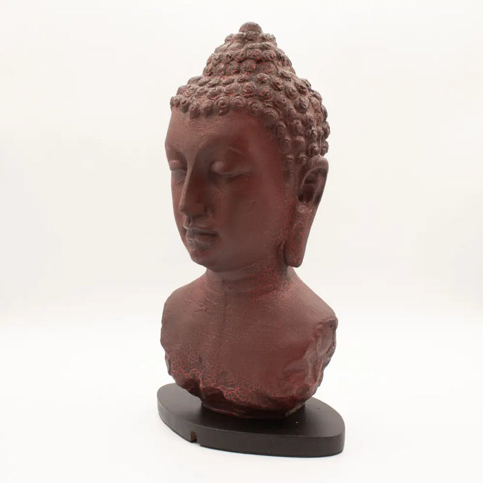 Red-brown buddha bust sculpture with curly hair on a dark wooden base featuring molton lava crackle texture