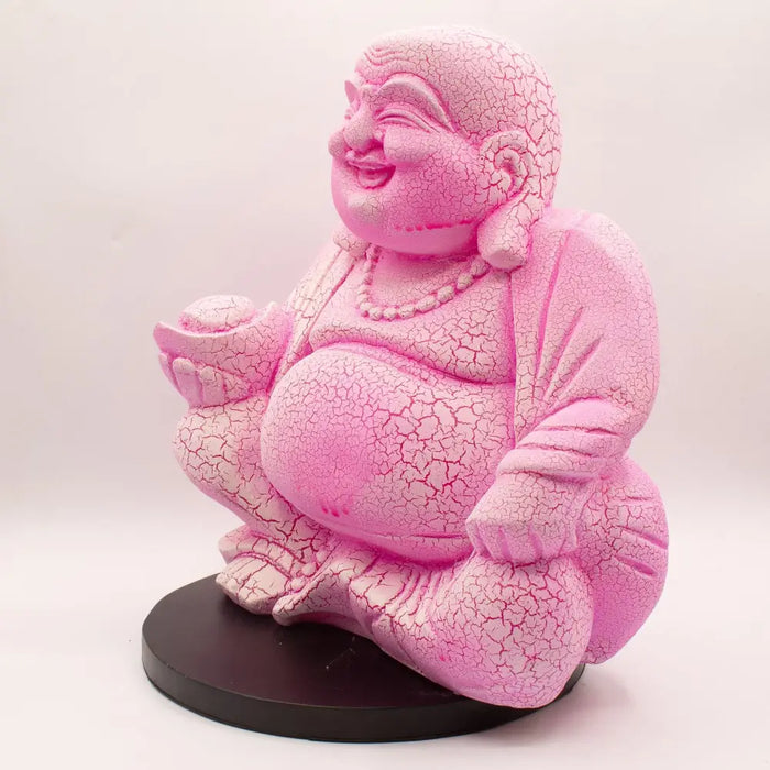 Pink cracked-finish laughing buddha figurine with dragonfruit crackle seated on a black base glowing lamp