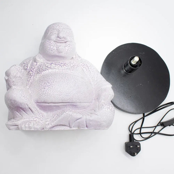 A laughing buddha lamp base made of crackled lavender resin on a black stand with a power cord visible