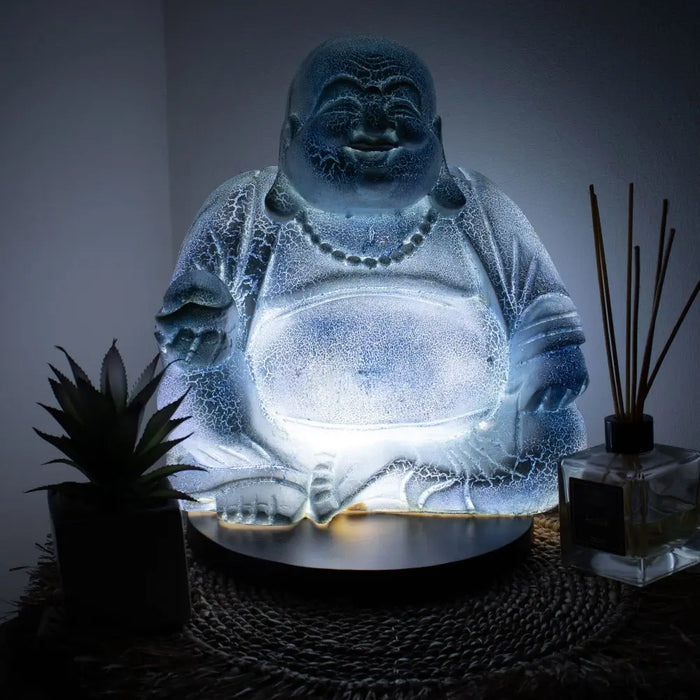 Illuminated laughing buddha glow lamp in sky blue with crackled glass finish and glowing base