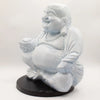 A white resin laughing buddha statue with cracked surface in a seated pose with sky blue crackle finish