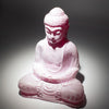 Pink cracked resin buddha statue with detailed face in traditional pose featuring cherry crackle texture for meditation use