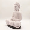 White cracked-finish buddha statue in seated meditation pose on dark base with lavender crackle glow lamp effect