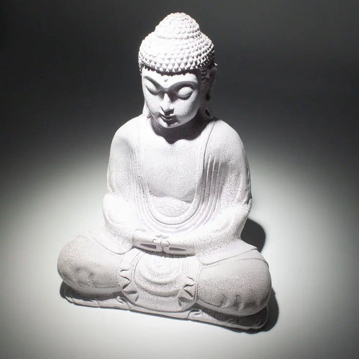 White stone buddha glow lamp with detailed robes and lavender crackle texture seated in a meditative pose