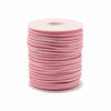 A spool of soft pink faux suede pendant cord neatly wound on a white plastic core for bulk roll pendant use