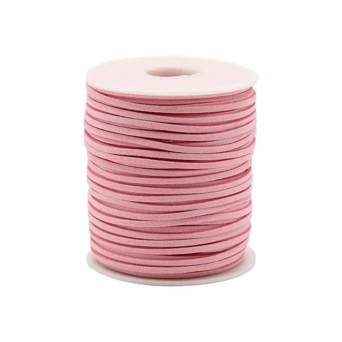 A spool of soft pink faux suede pendant cord neatly wound on a white plastic core for bulk roll pendant use