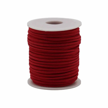 A bulk roll pendant cord in vibrant red faux suede neatly wound on a white plastic core spool