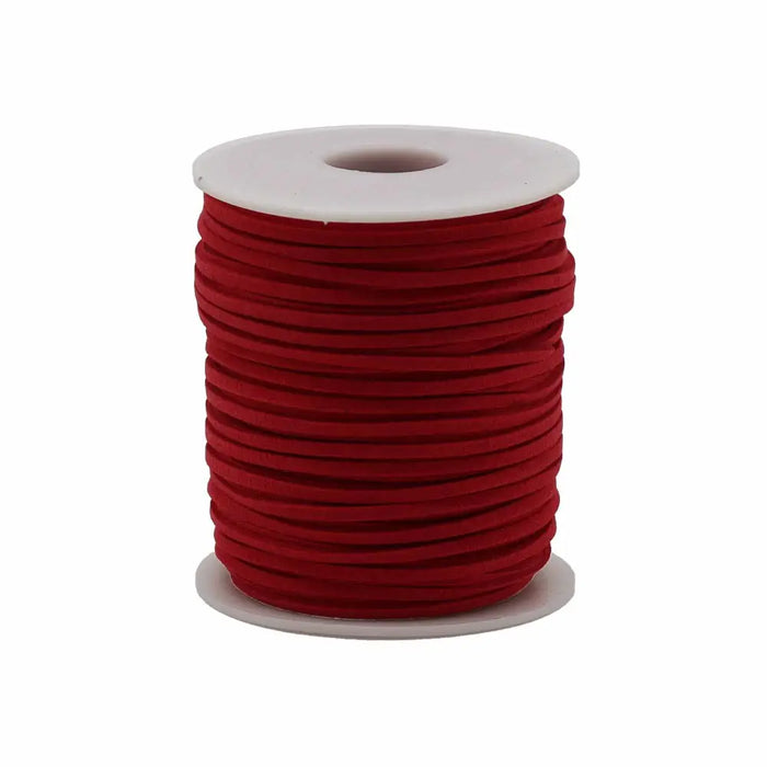 A bulk roll pendant cord in vibrant red faux suede neatly wound on a white plastic core spool
