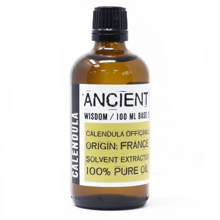 An amber glass bottle of calendula oil with a black cap and white label showing ancient wisdom 100 ml base oil