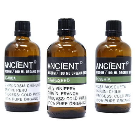 Three amber glass bottles of calendula organic base oil with cold-pressed jojoba grape seed and rosehip for skin cell regeneration