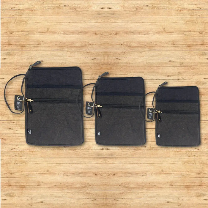 Three stonewash charcoal canvas laptop travel pouches with zipper closures and attached straps showing small tags