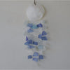 A blue and white capiz shell and glass wind chime with translucent sea glass pieces and a frosted white shell top