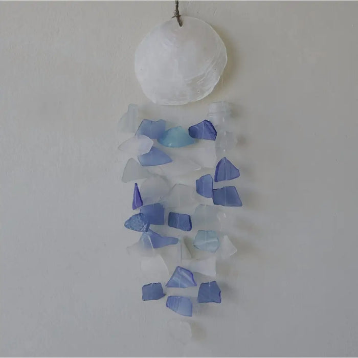 A blue and white capiz shell and glass wind chime with translucent sea glass pieces and a frosted white shell top