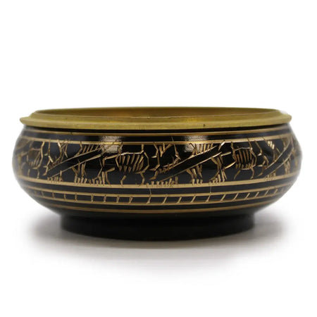 Black and gold carved brass incense jar with intricate animal motifs engraved along the rim