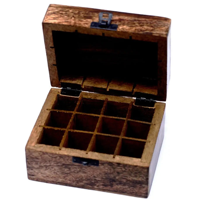 A carved mango wood aromatherapy box with nine compartments and black metal hinges for essential oils storage