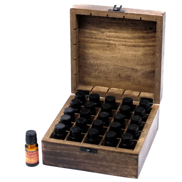 A rustic carved mango wood box with hinged lid holding 24 amber glass essential oils bottles with black caps